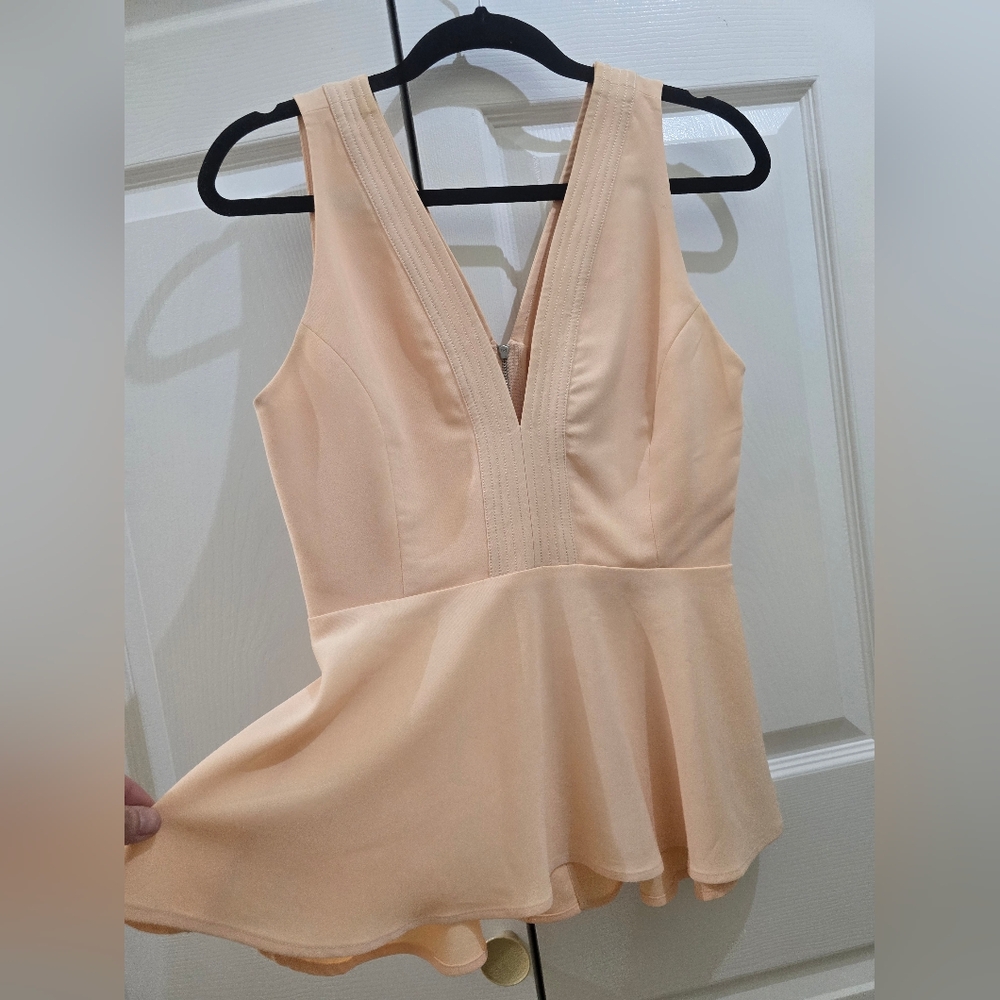Elegant Peach Sleeveless Peplum Top
